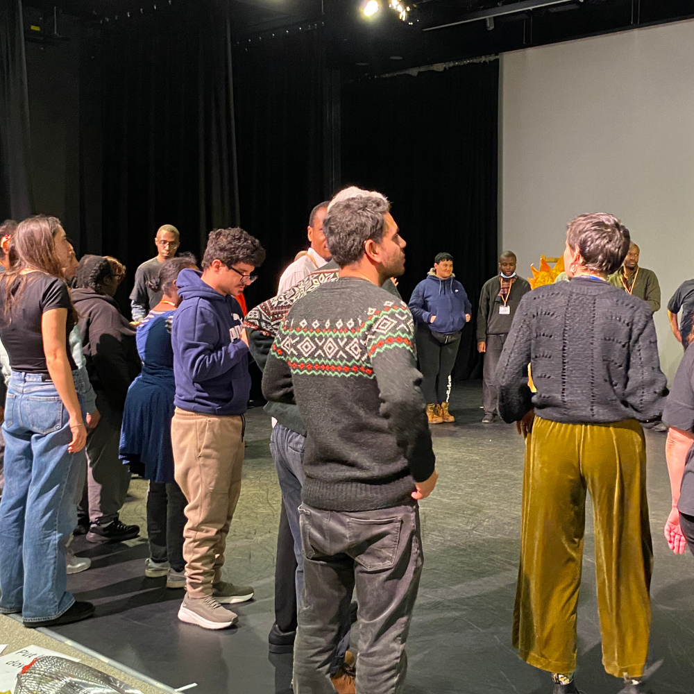 The audience on stage for a dance circle