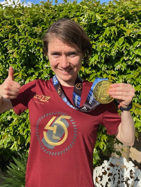 Georgia shows off her medal from the marathon