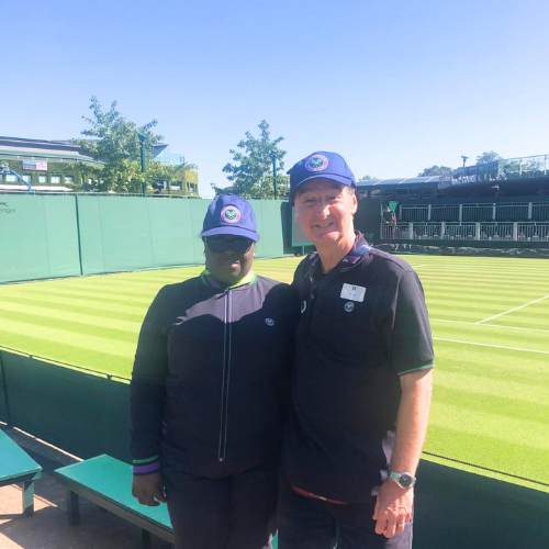 Anna-Marie stands with her manager alongside one of the Wimbledon courts