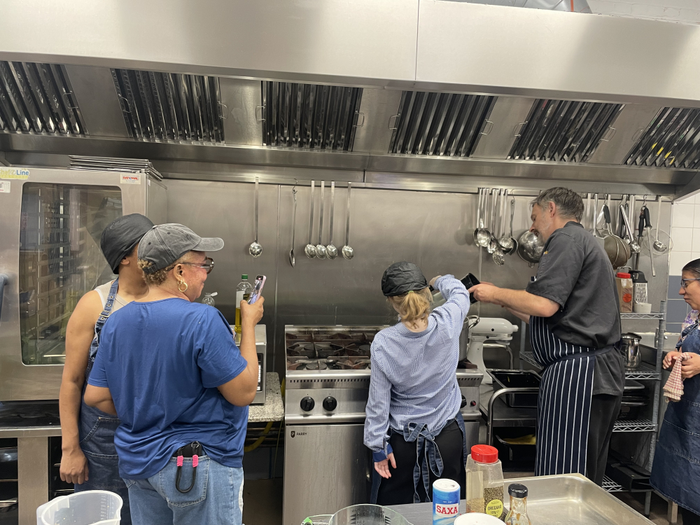 Ella, pouring water into a pot with Chef Tim