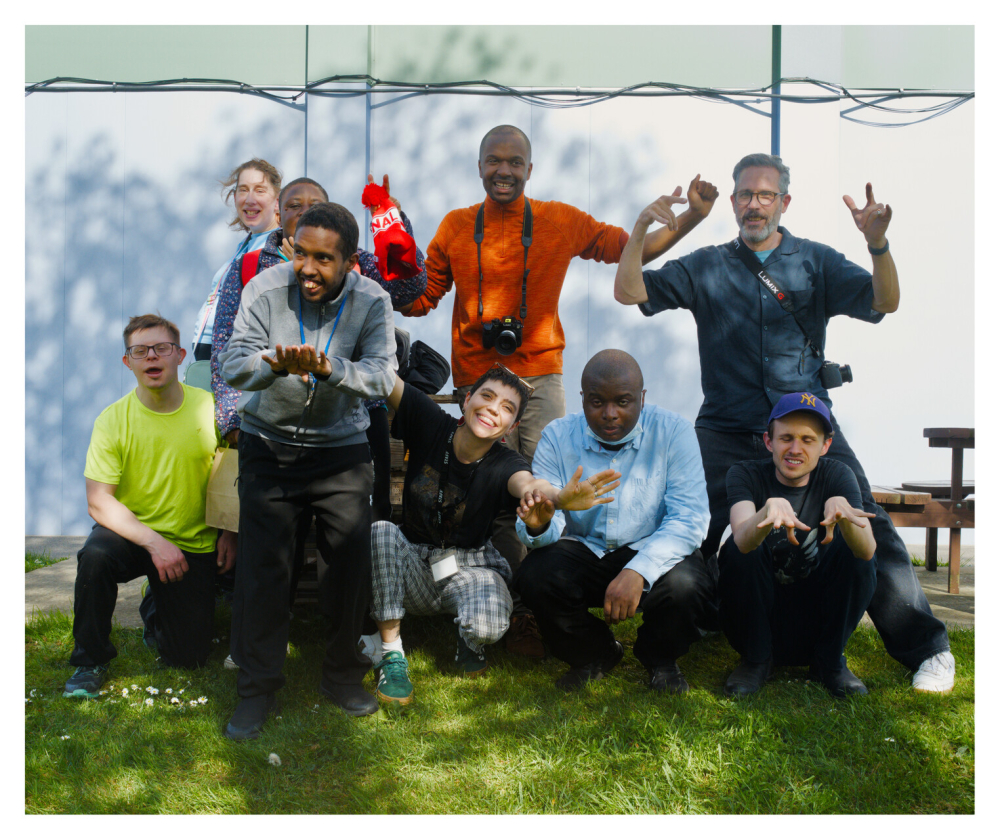 Group photo of photography students waving at the camera