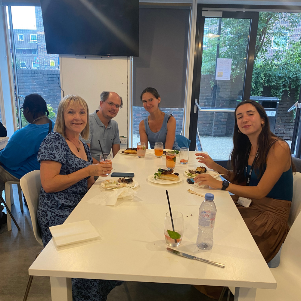 A family sit at a table at the supper club awaiting food