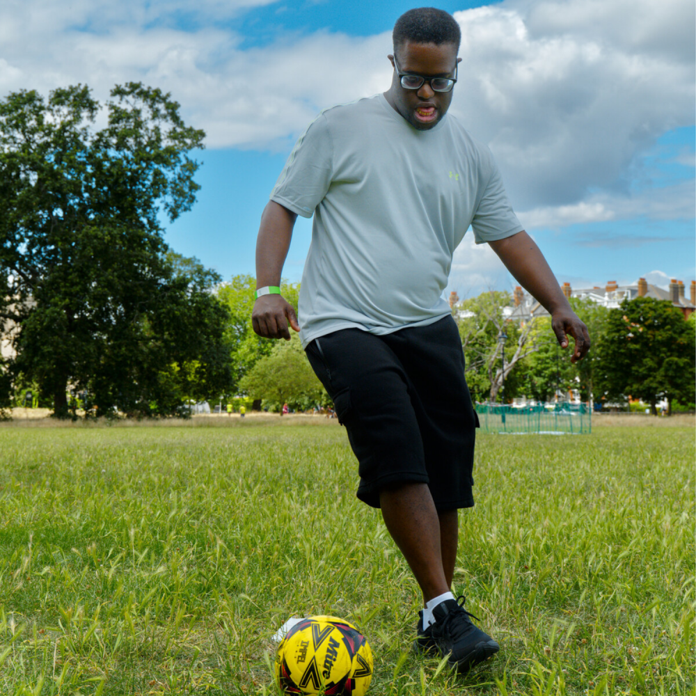 A close up of a man dribbling a football