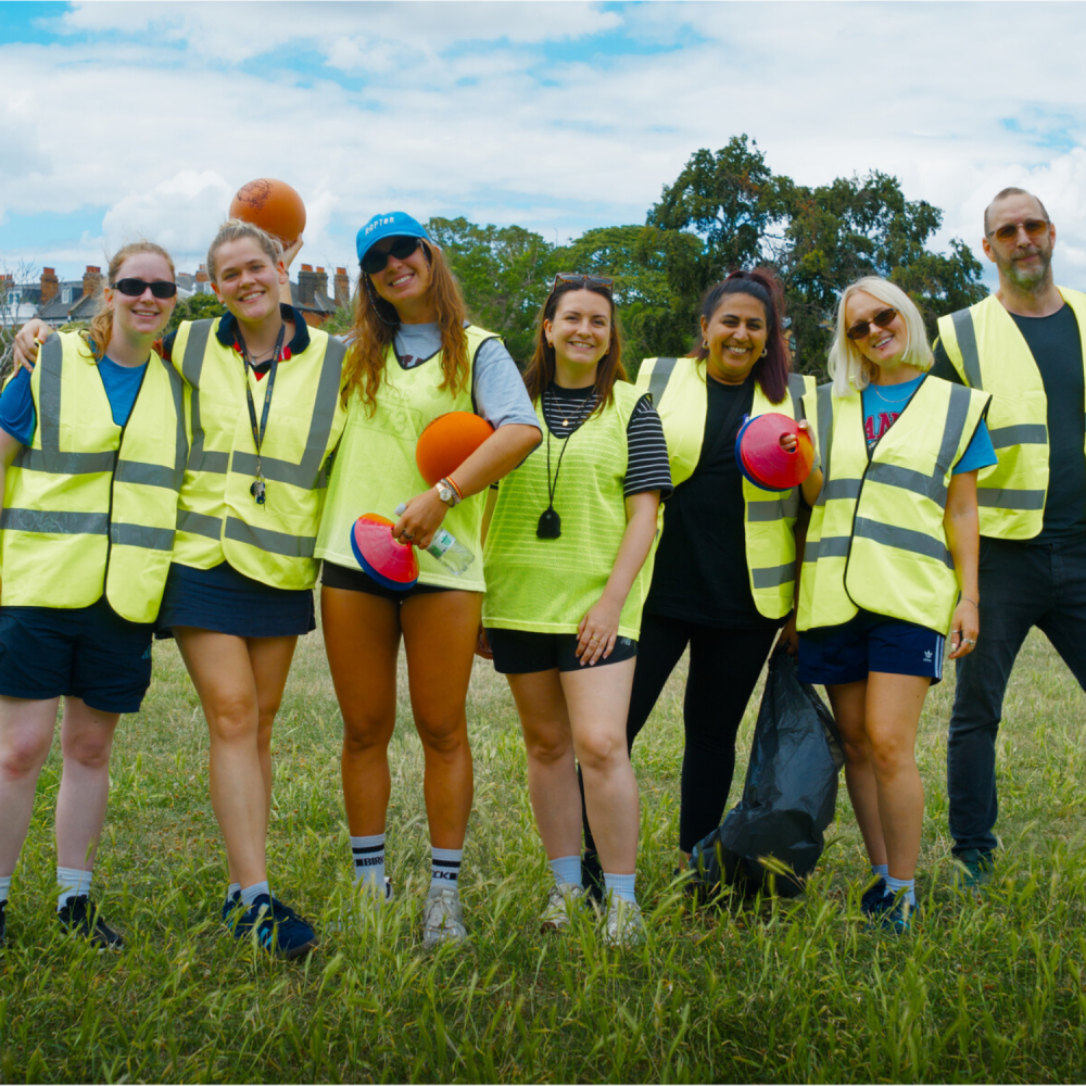 Group of the volunteers in high vis standing and posing as a group for the camera in the park