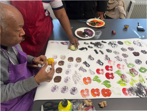 Share students using vegetables and paint to make prints on paper.