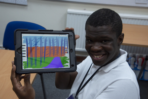 Shaun showing his digital artwork on the ipad