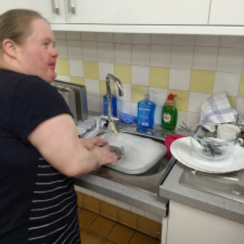 Claire washing up in the new teaching kitchen