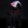 Lady in a wheelchair wears bespoke headwear that mostly covers her face