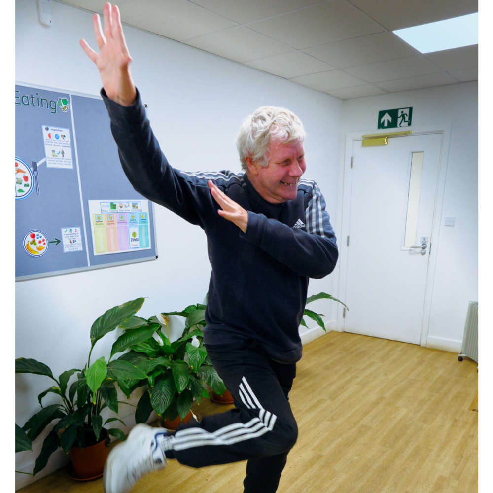 A man stands doing a silly dance