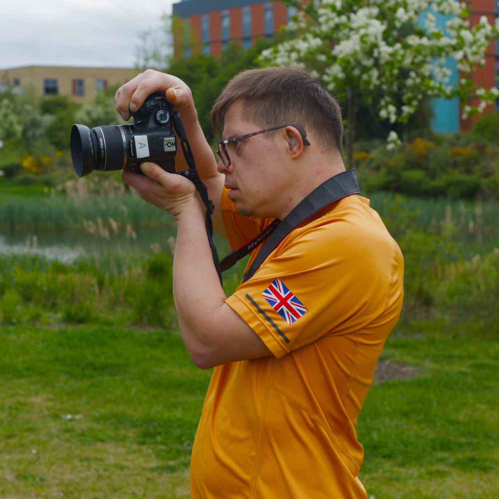 Close up of a man taking a photo on a professional camera